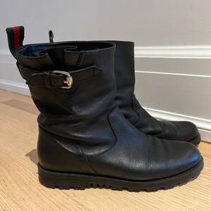 Black leather women’s Gucci moto boots.